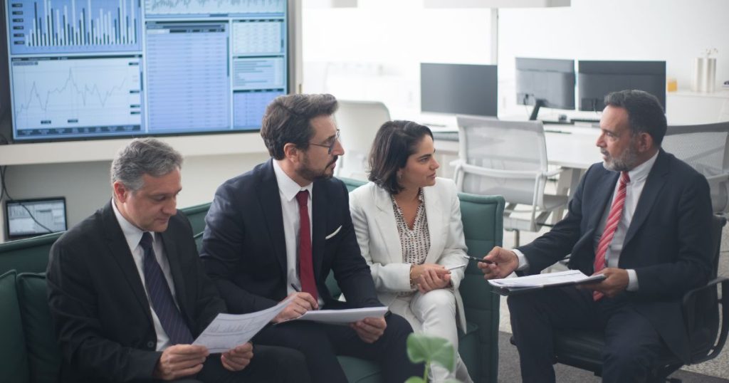 Business owners discussing business funding requirements with financial advisors during a funding consultation