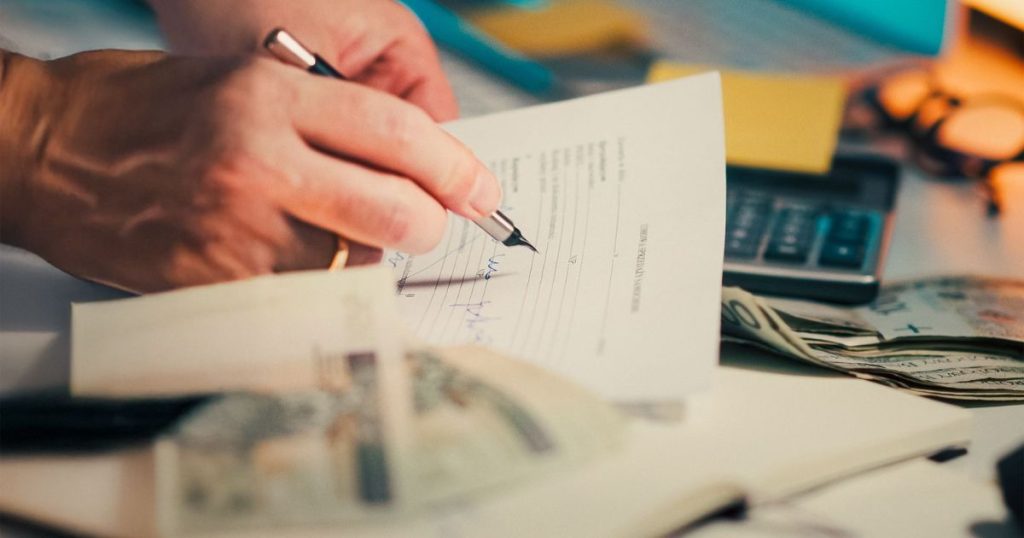 Business owner preparing documents needed for a business loan application and financing review