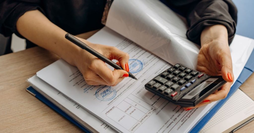 Business owner reviewing financial documents required for business funding requirements