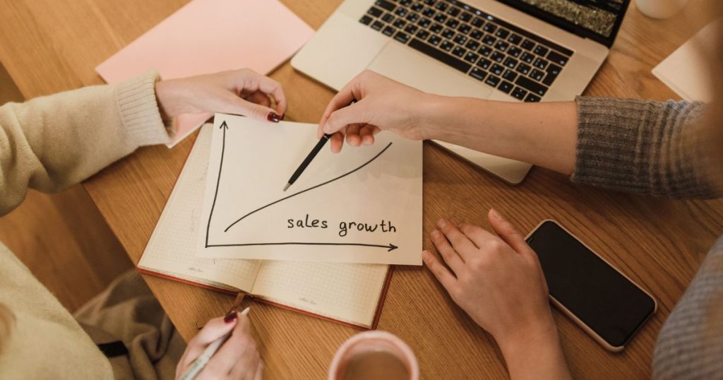Business owners reviewing company history documents to meet time in business requirements for business funding