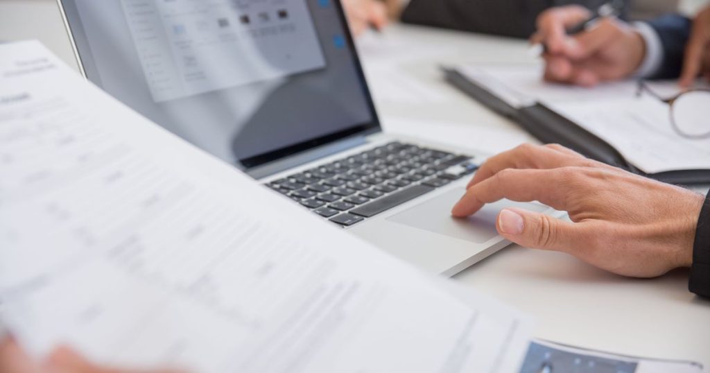 Business owner preparing documents required for business funding application and financial review